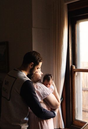 Series of intimate silhouettes near a window during golden hour creating a warm, romantic mood.