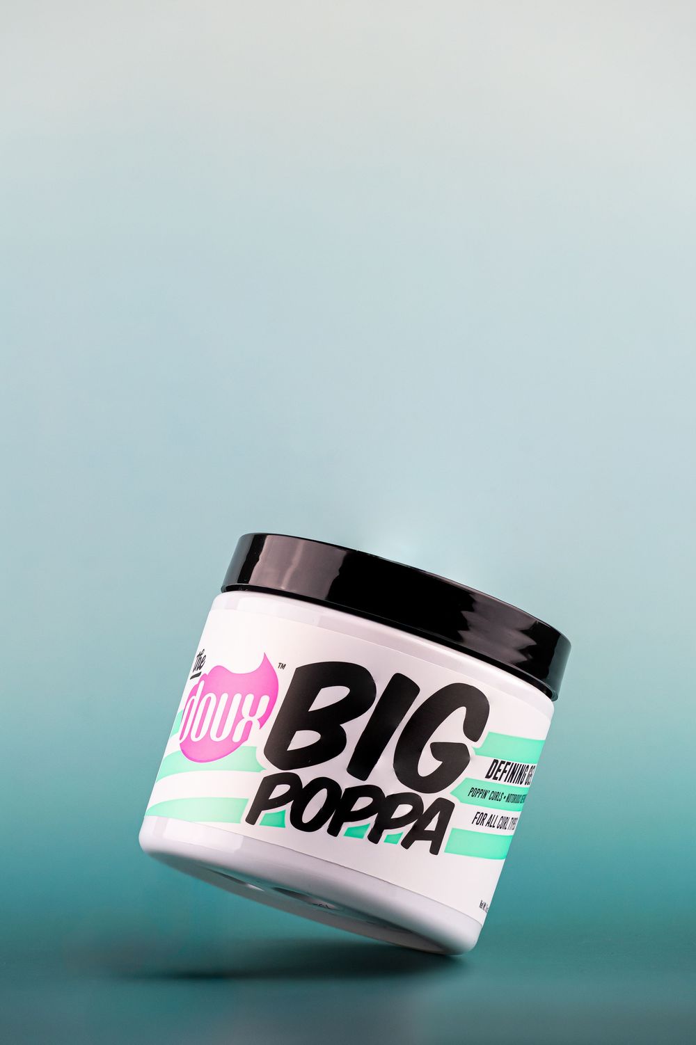 NOUHI Big Poppa defining curl cream jar in white with black lid, floating against a teal gradient background.