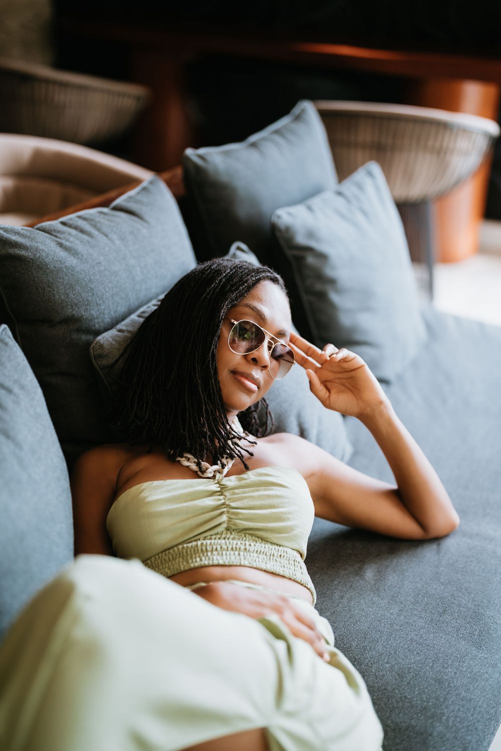 Relaxing scene on grey couch with soft natural lighting.
