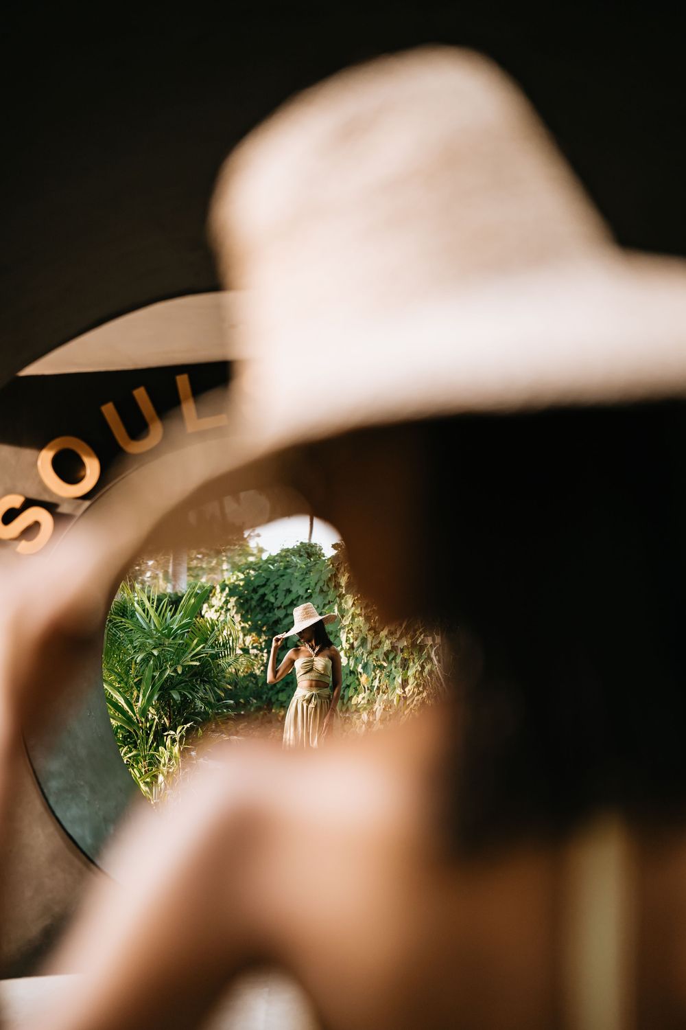 Creative photo through sunglasses showing tropical garden view.