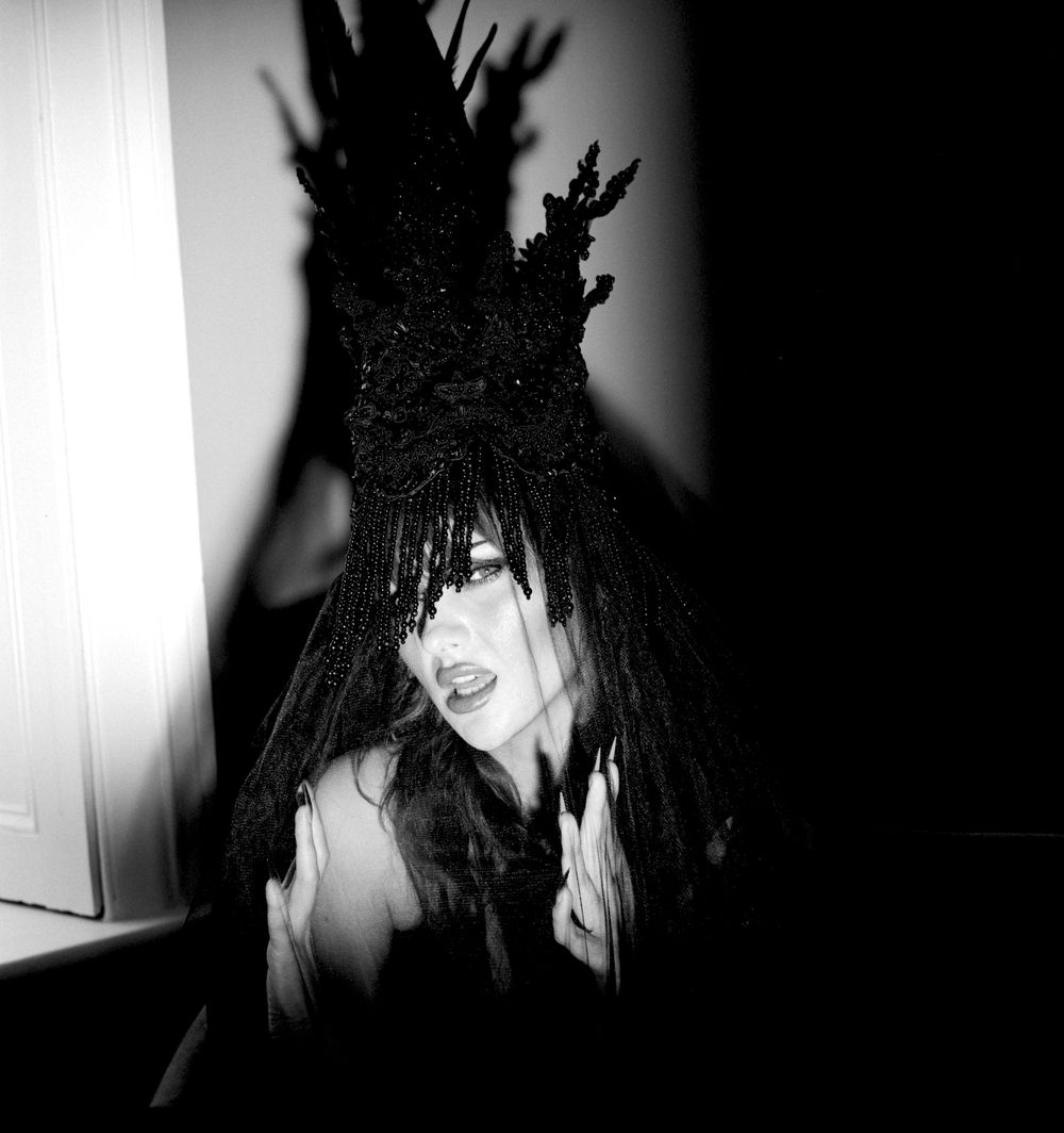 Creative black and white fashion photograph of model Jessica Wilcock wearing head dress by Jay Briggs Millinery
