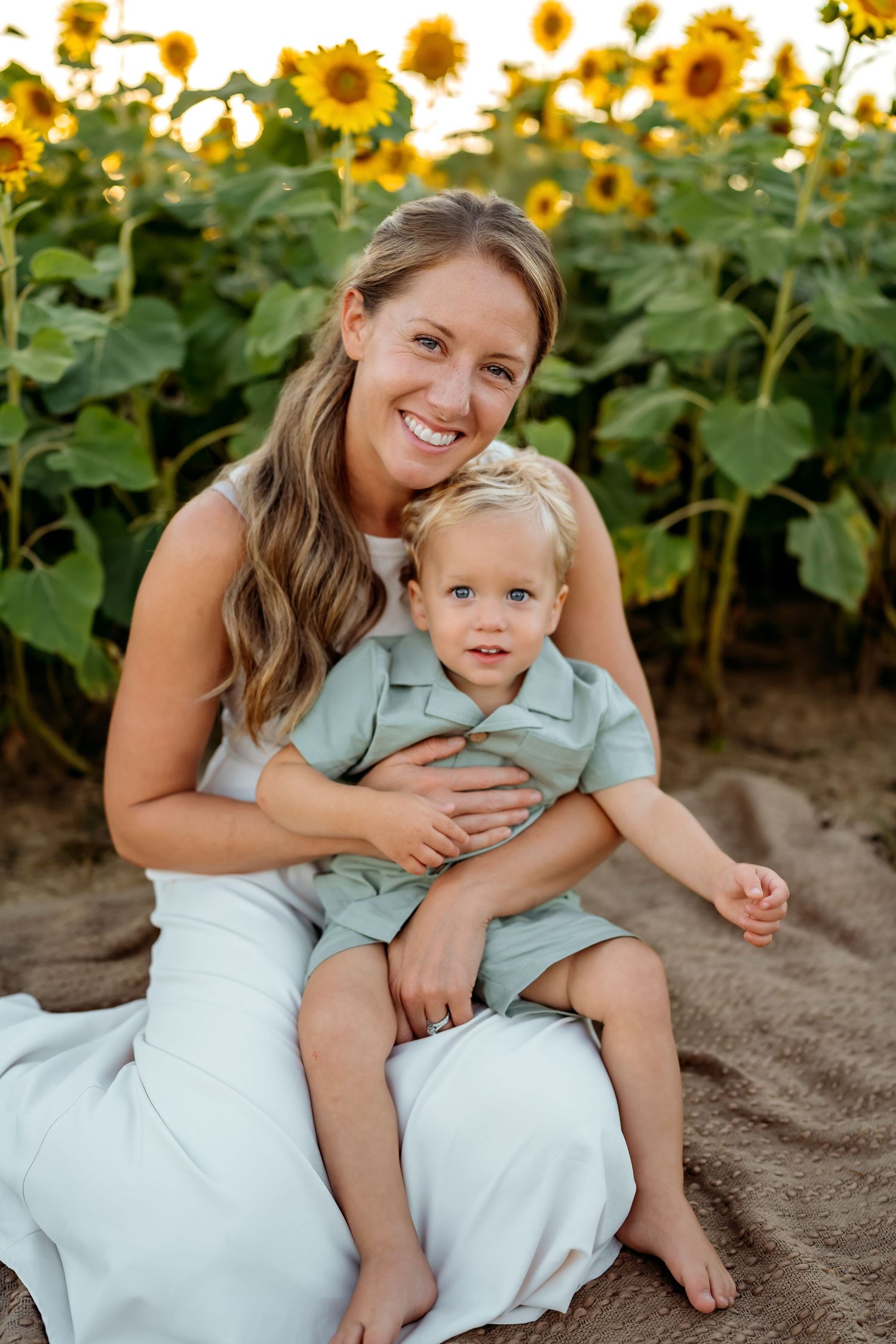 Candid family moments captured against a backdrop of golden sunflowers during sunset.