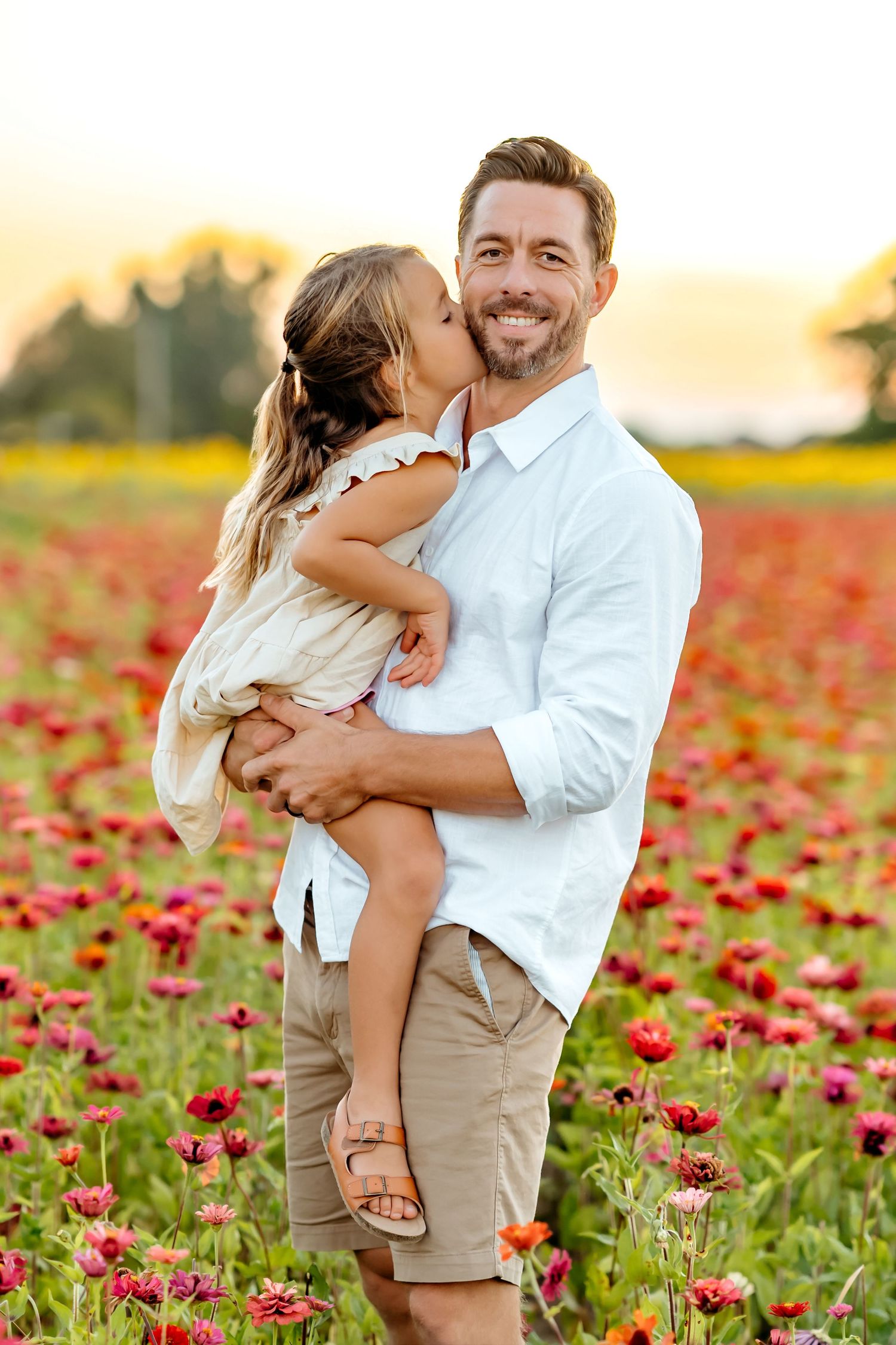 Tender family moments captured in a field of red poppies during golden hour.