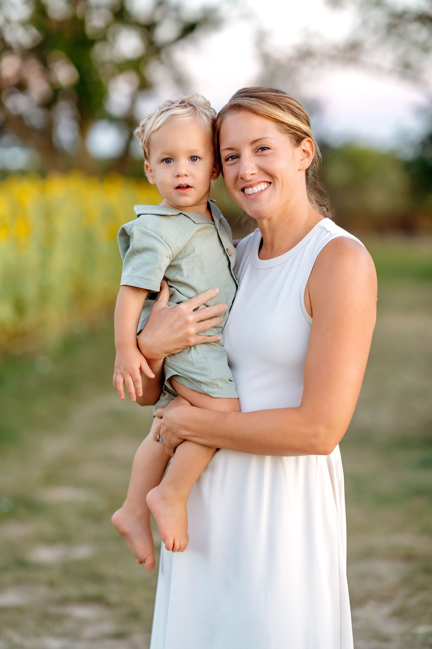 Parent and young child sharing sweet moments together in outdoor setting.