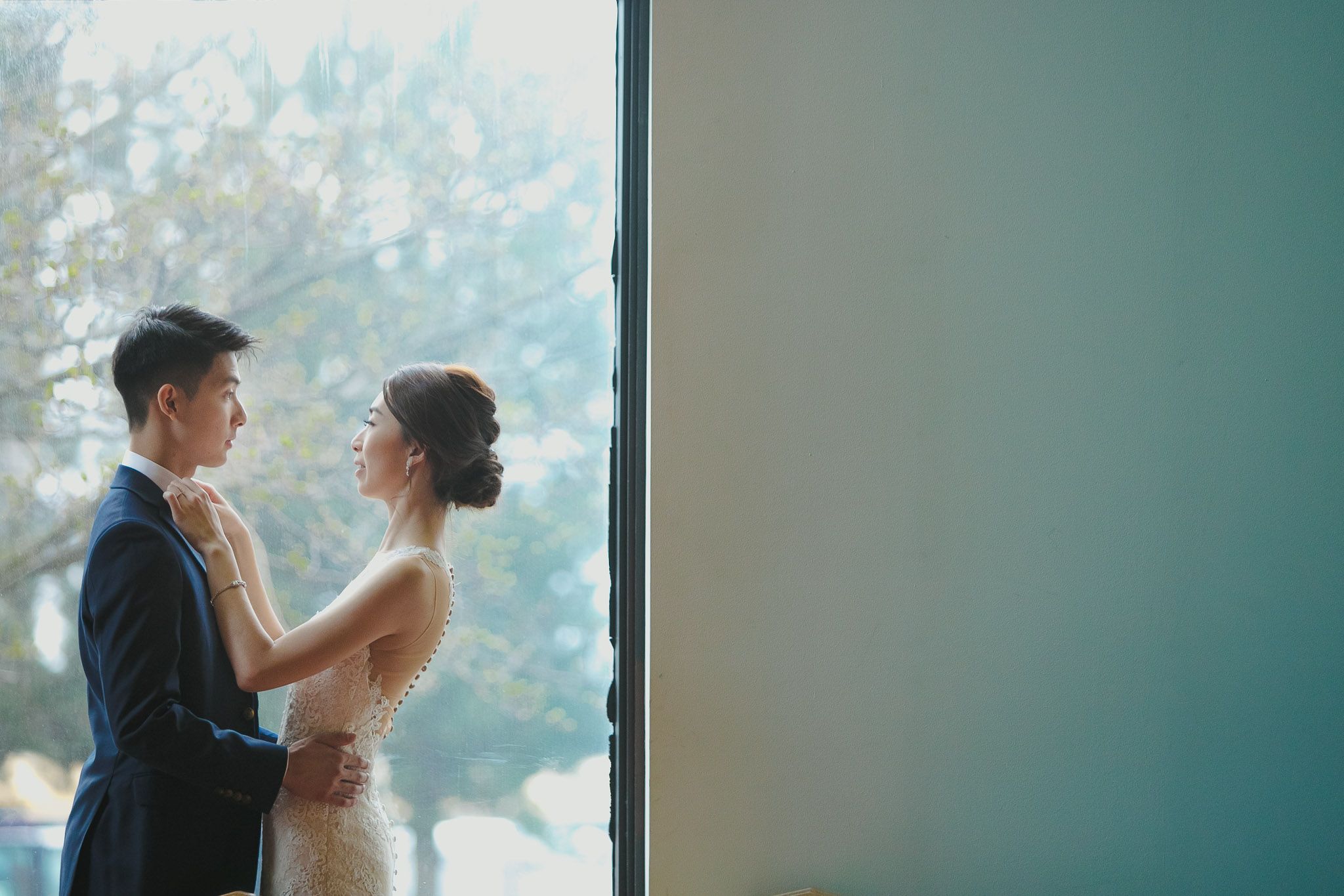 Intimate wedding moments captured against soft window lighting.