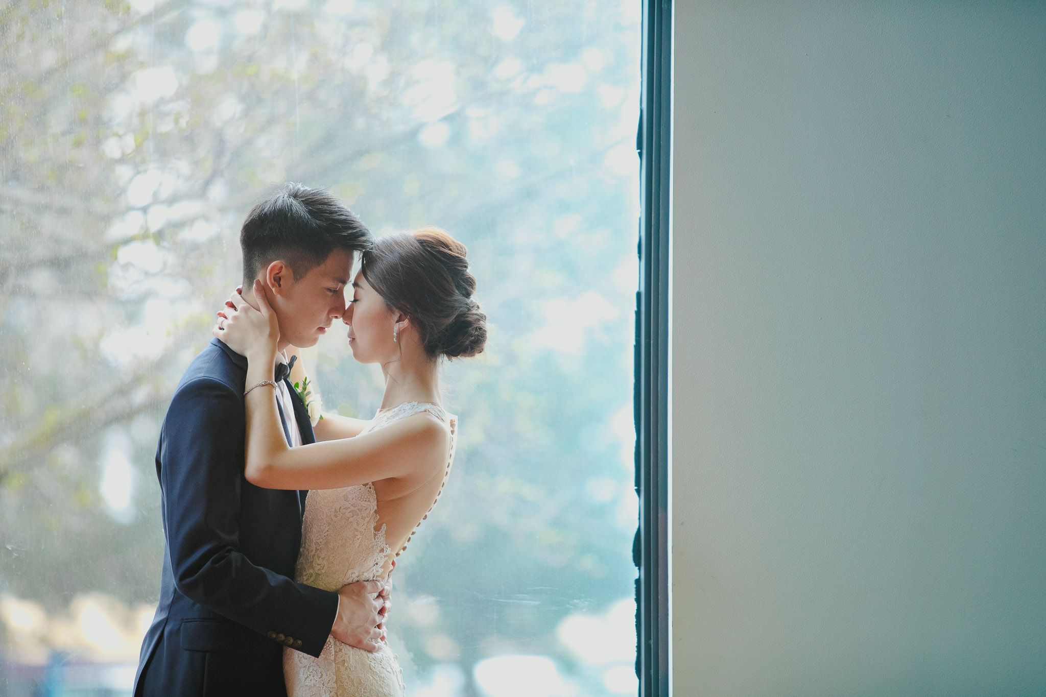 A romantic moment captured against a bright blue sky background.
