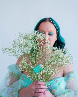 Dreamy portrait series with baby's breath flowers and turquoise hair styling.