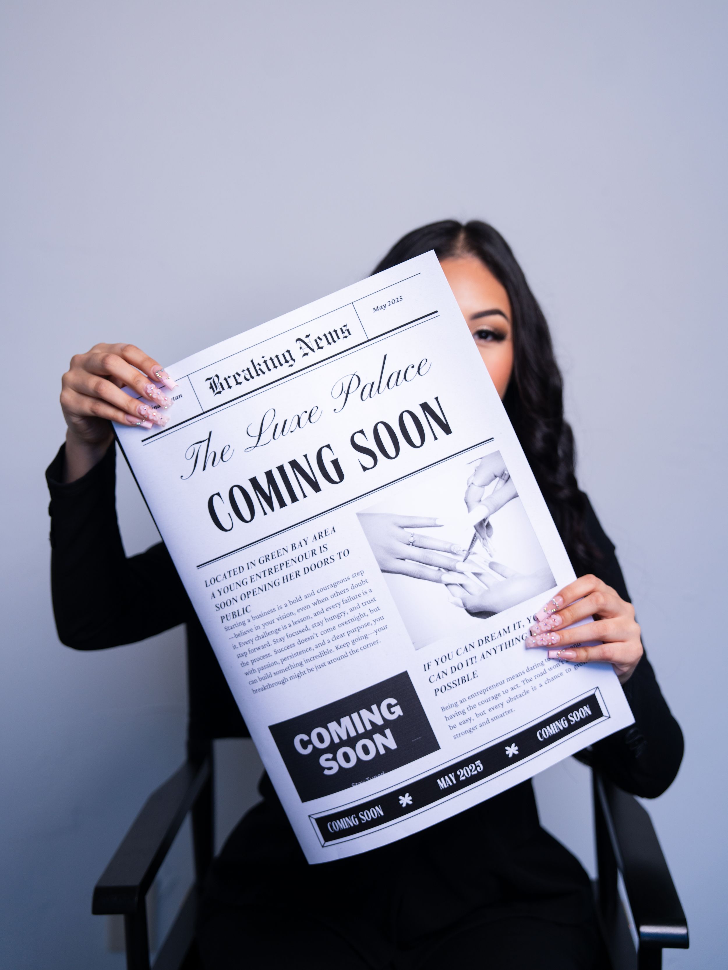 Professional holding a newspaper-style announcement with 'Coming Soon' text against grey background.