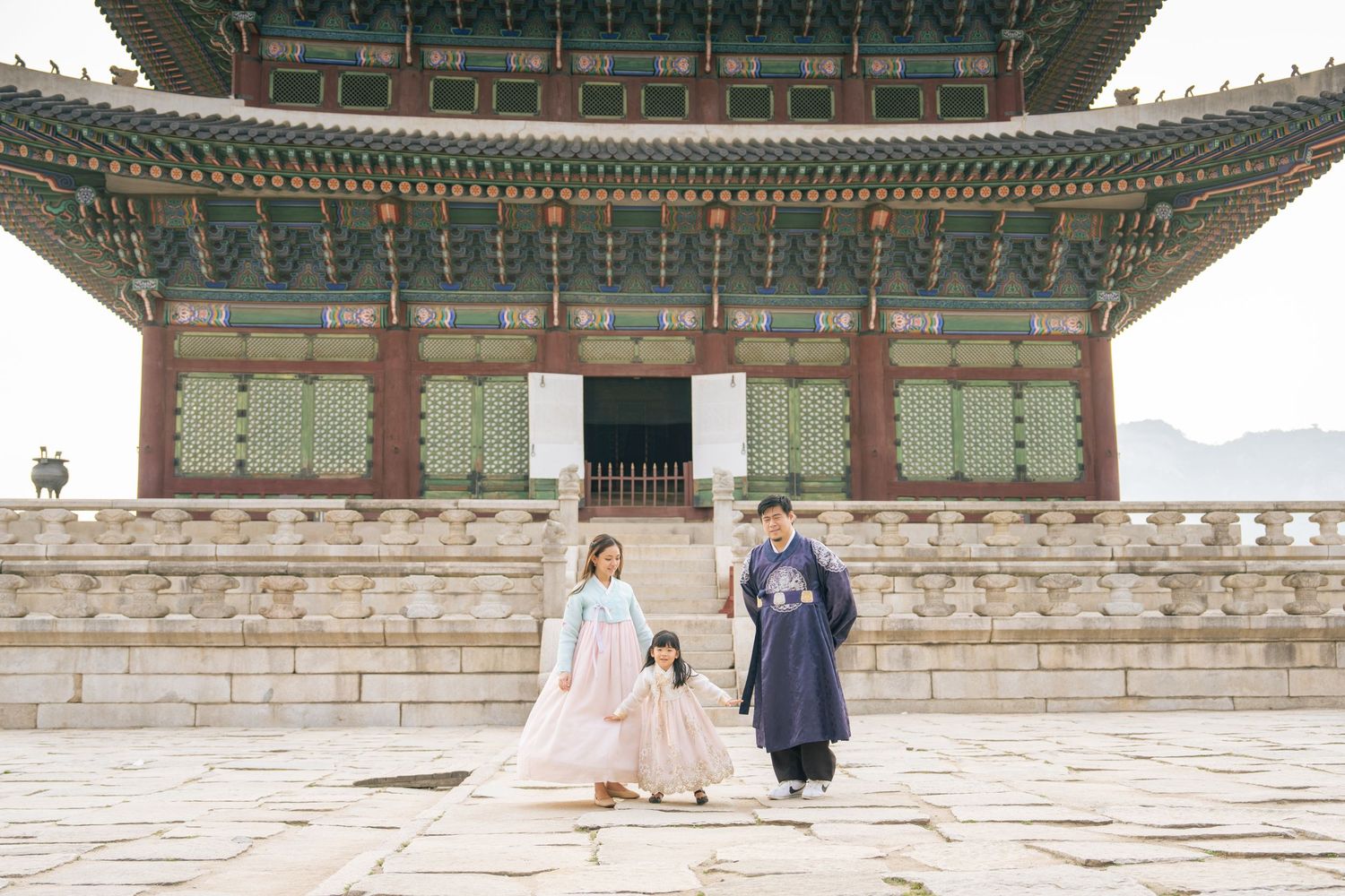 Traditional Korean palace architecture with ornate green roof details against clear sky.
