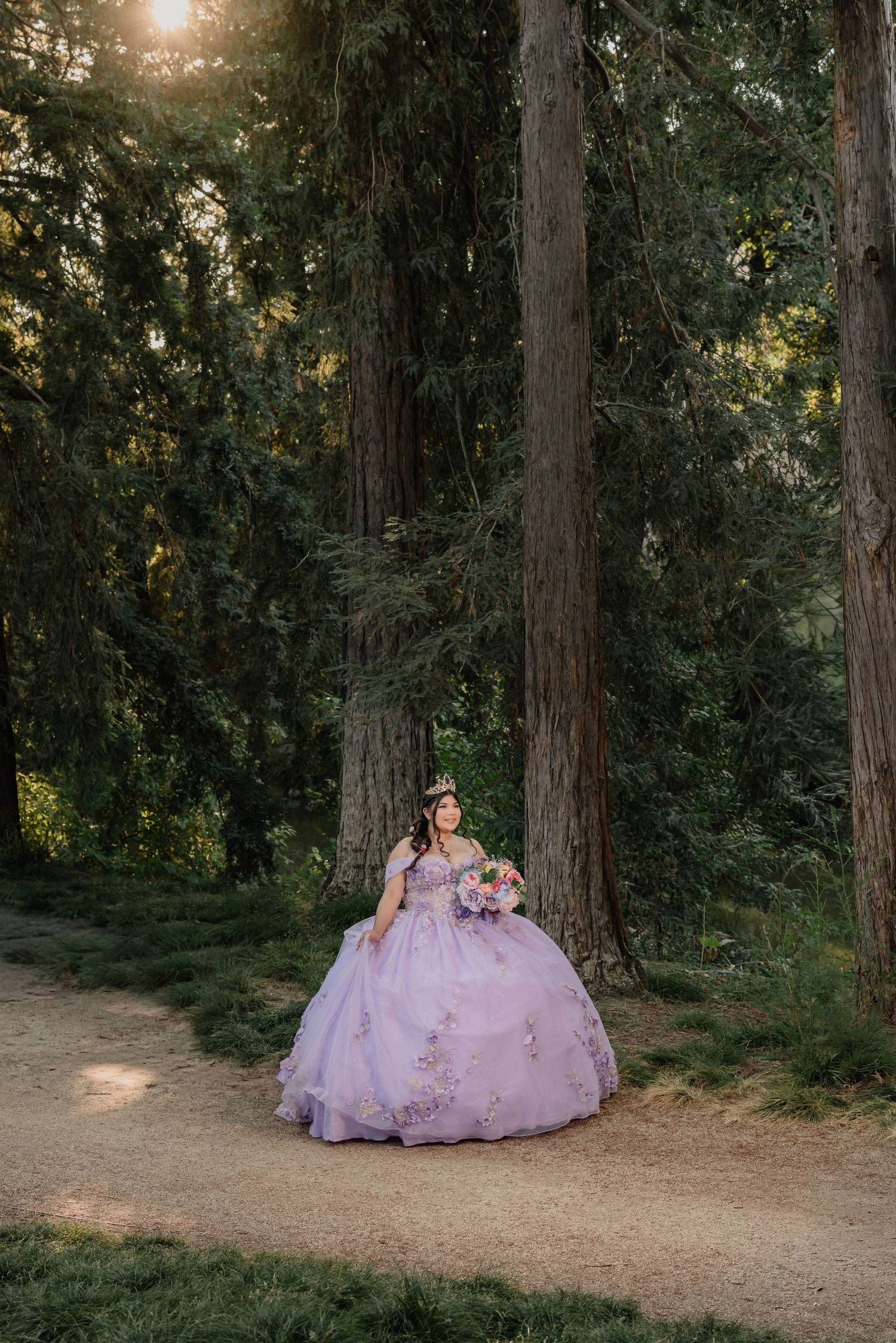 A series of enchanting woodland portraits featuring a lavender ballgown amid tall trees at golden hour.