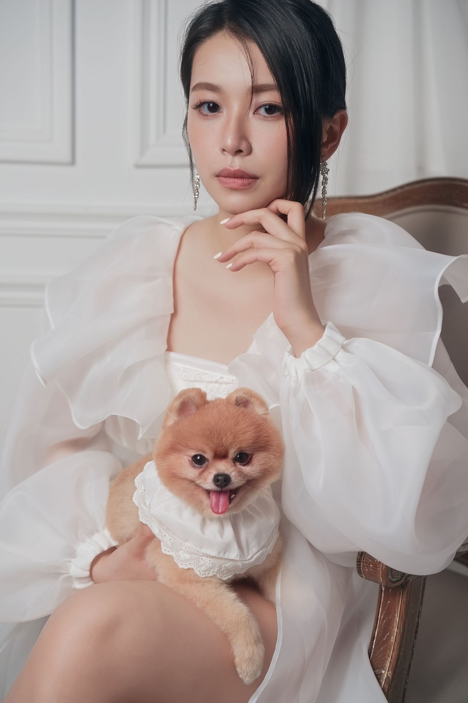 Person in white fitted wedding dress posing against light background.
