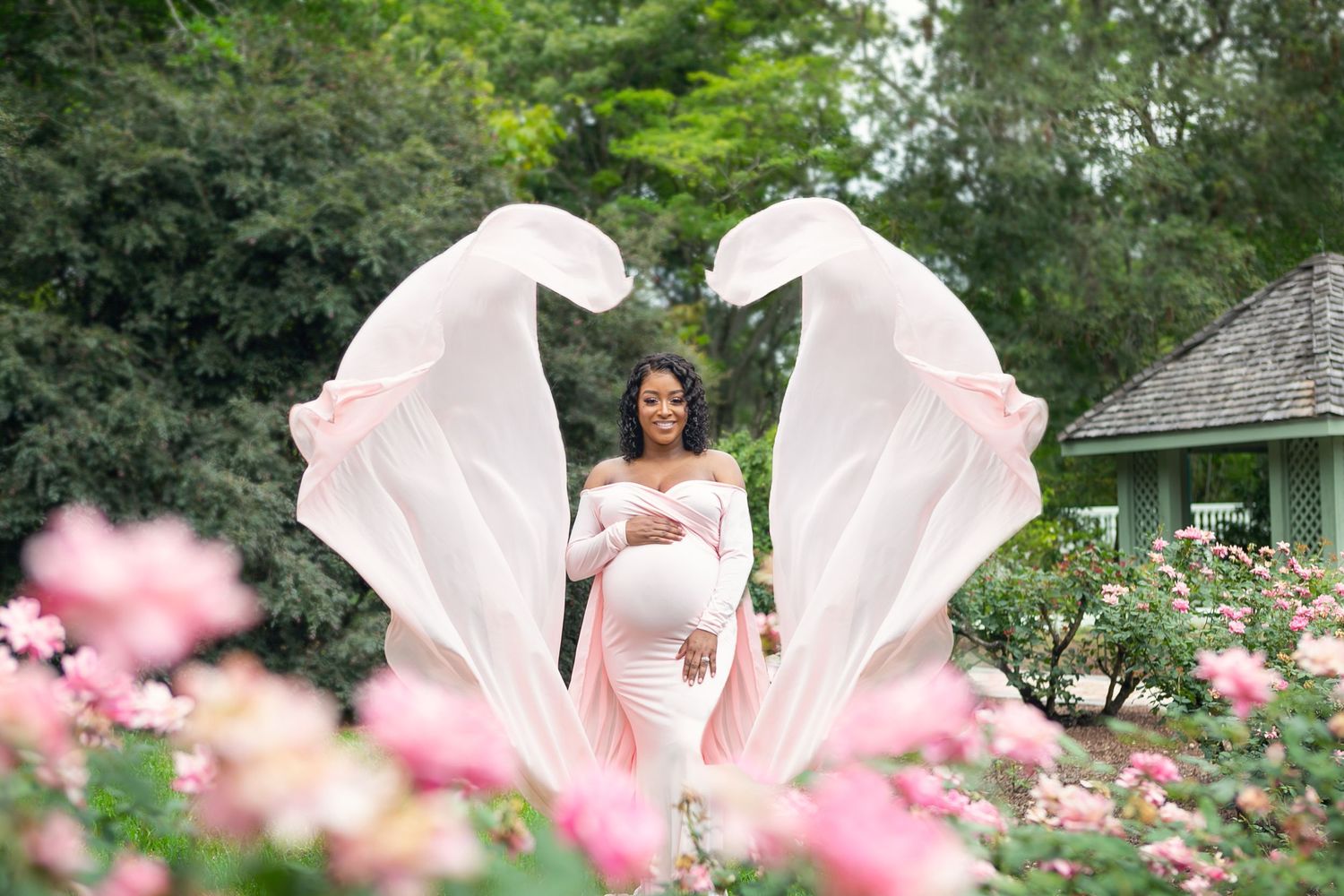 A beautiful Leu Gardens maternity photo, displays pink cosmos flowers blooming, Orlando Maternity Photography, Sanford Maternity Photography