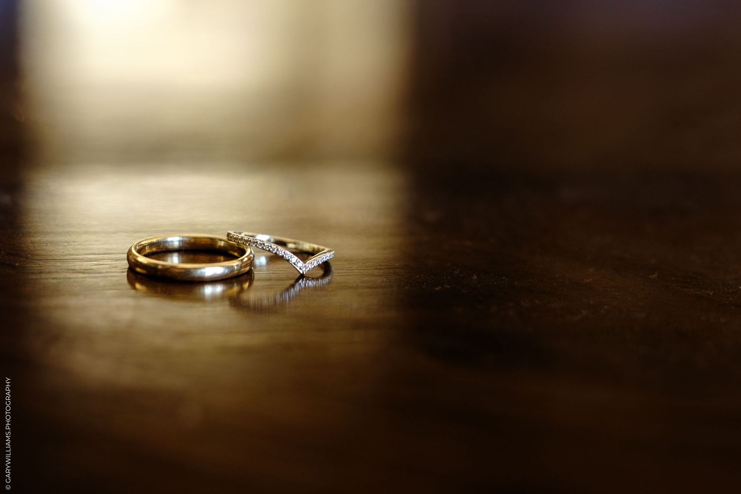 Seven artistic macro shots of gold wedding rings display various angles on dark backgrounds with dramatic lighting effects.