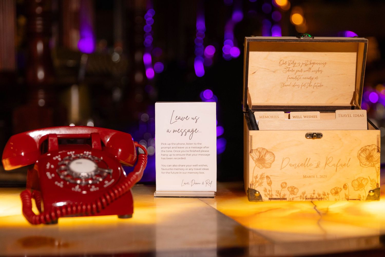 Wedding reception place cards and table numbers set up on display with elegant lighting effects.