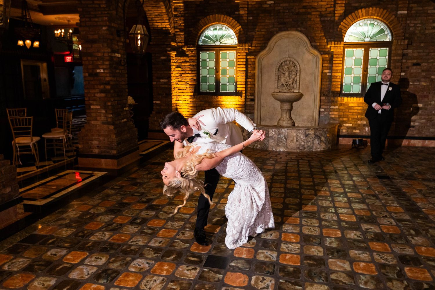 Dance sequence on a patterned floor showcasing romantic wedding moments in warm lighting.