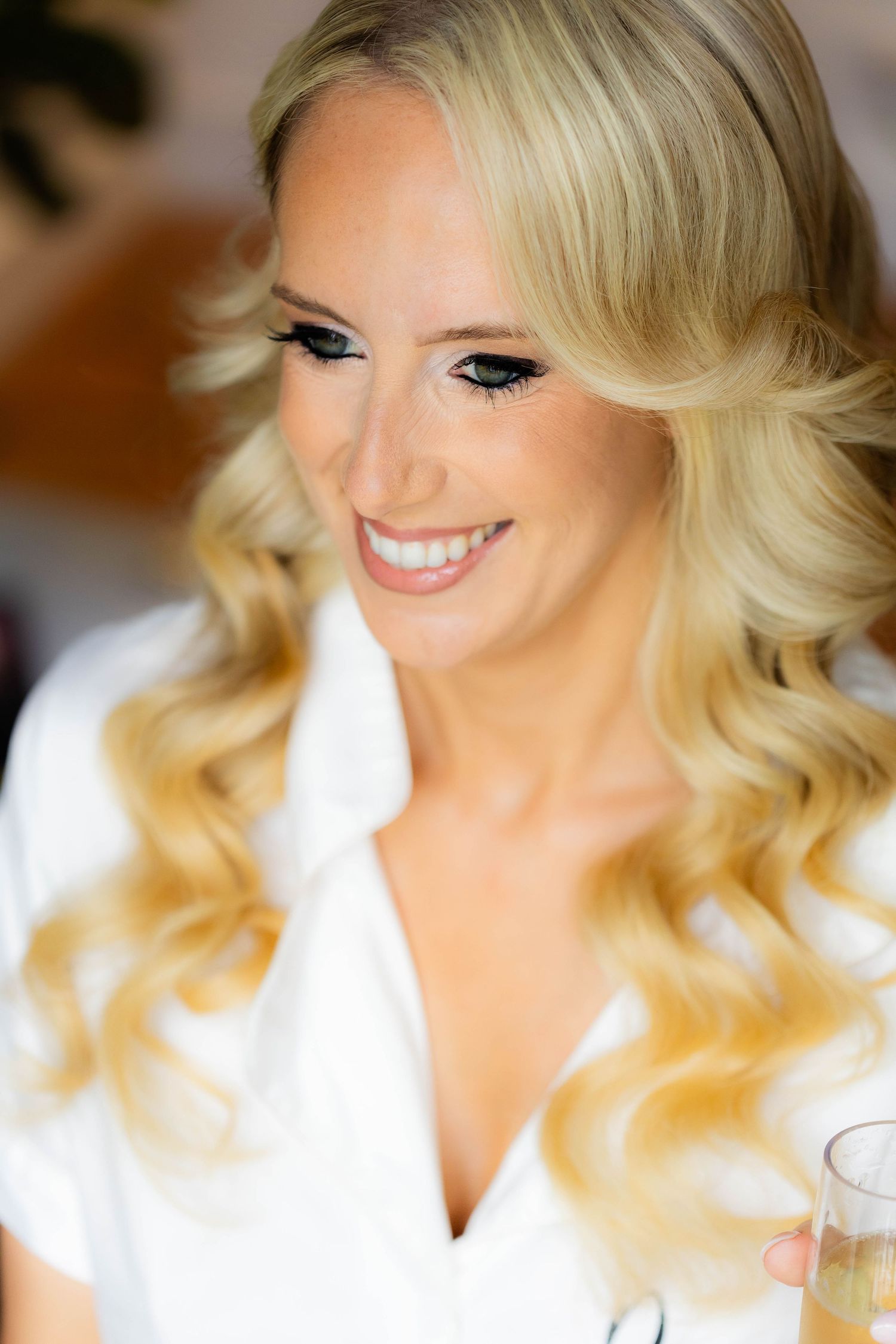 A series of close-up beauty shots showing a blonde woman with styled hair and makeup smiling in natural light.