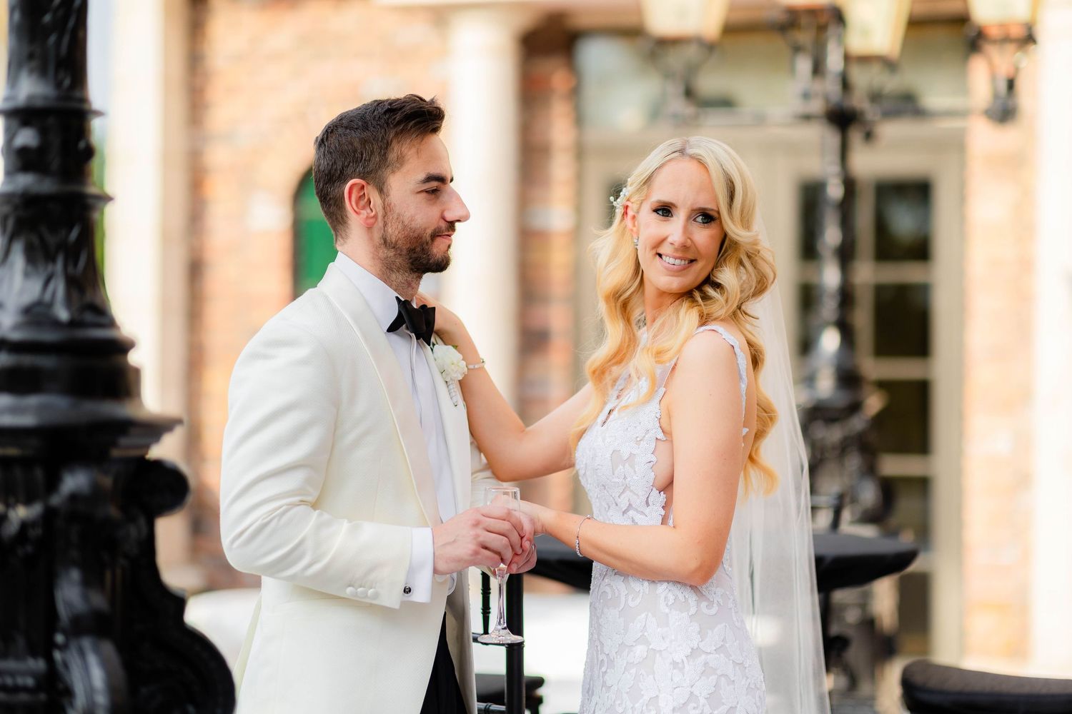 Couple enjoys an intimate dance moment outdoors near ornate architecture.