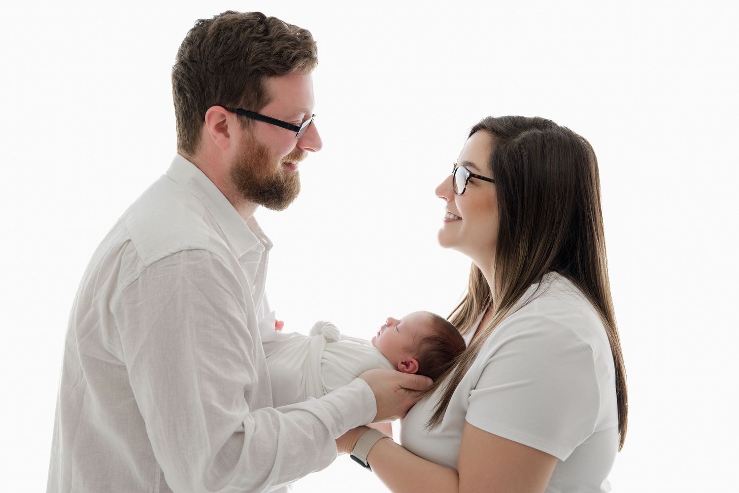 A joyful sequence of candid interactions between a couple in white outfits against a white background.