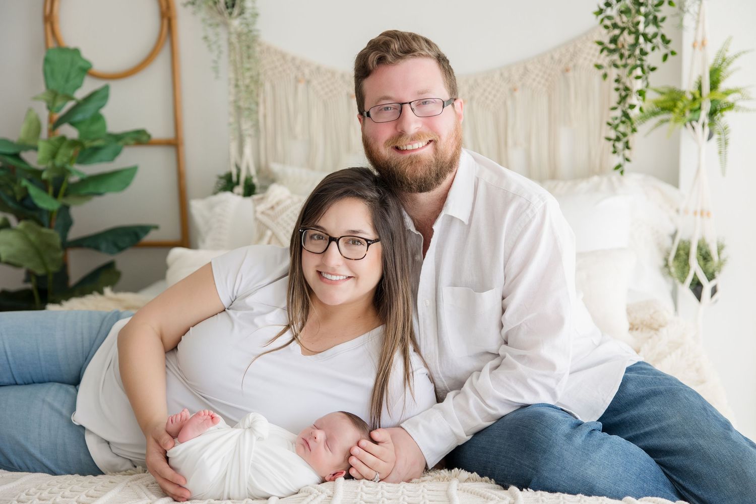 A family lounging together in a bright, minimalist room with natural lighting and greenery.