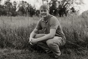 Black and white portraits showing candid moments in a grassy field.