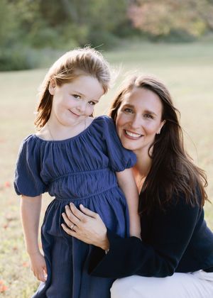 A heartwarming series of candid moments captured in a sunny outdoor setting with navy blue and black clothing.