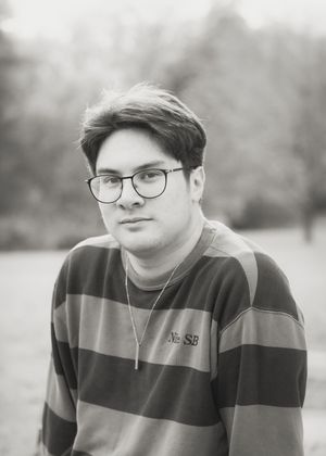 Black and white portrait series showing different expressions and angles of someone wearing glasses and a striped shirt.