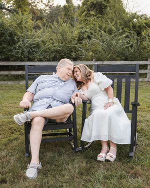 Sweet moments shared on a wooden bench in a park setting.