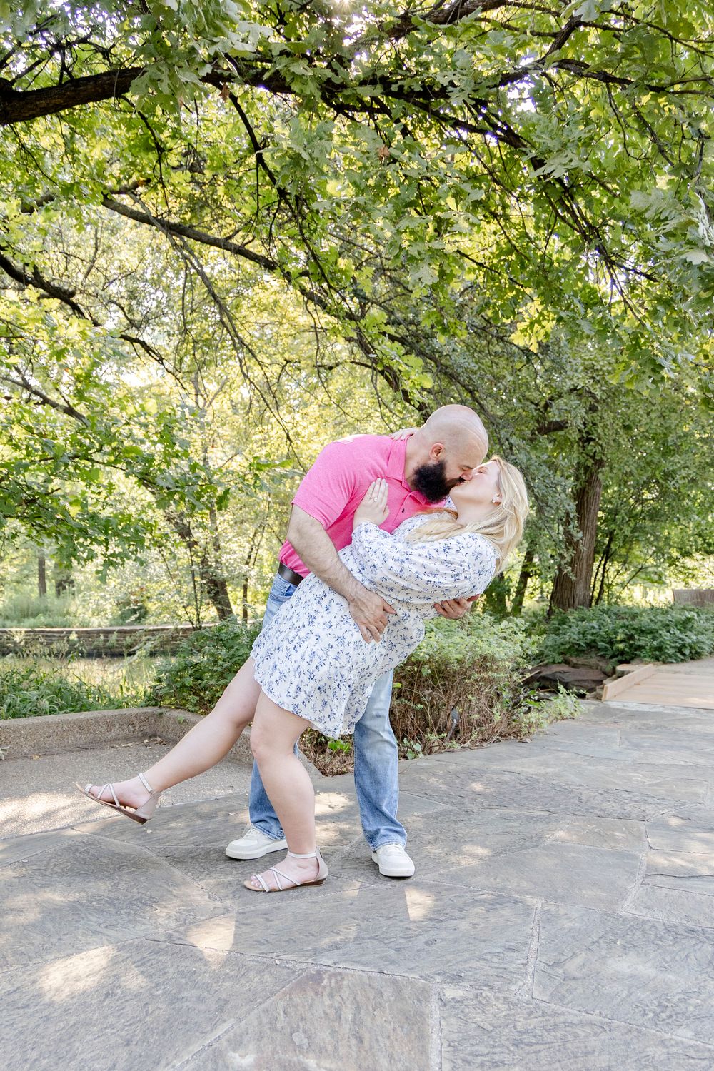 Engaged couple walking through Fort Worth Botanical Gardens
