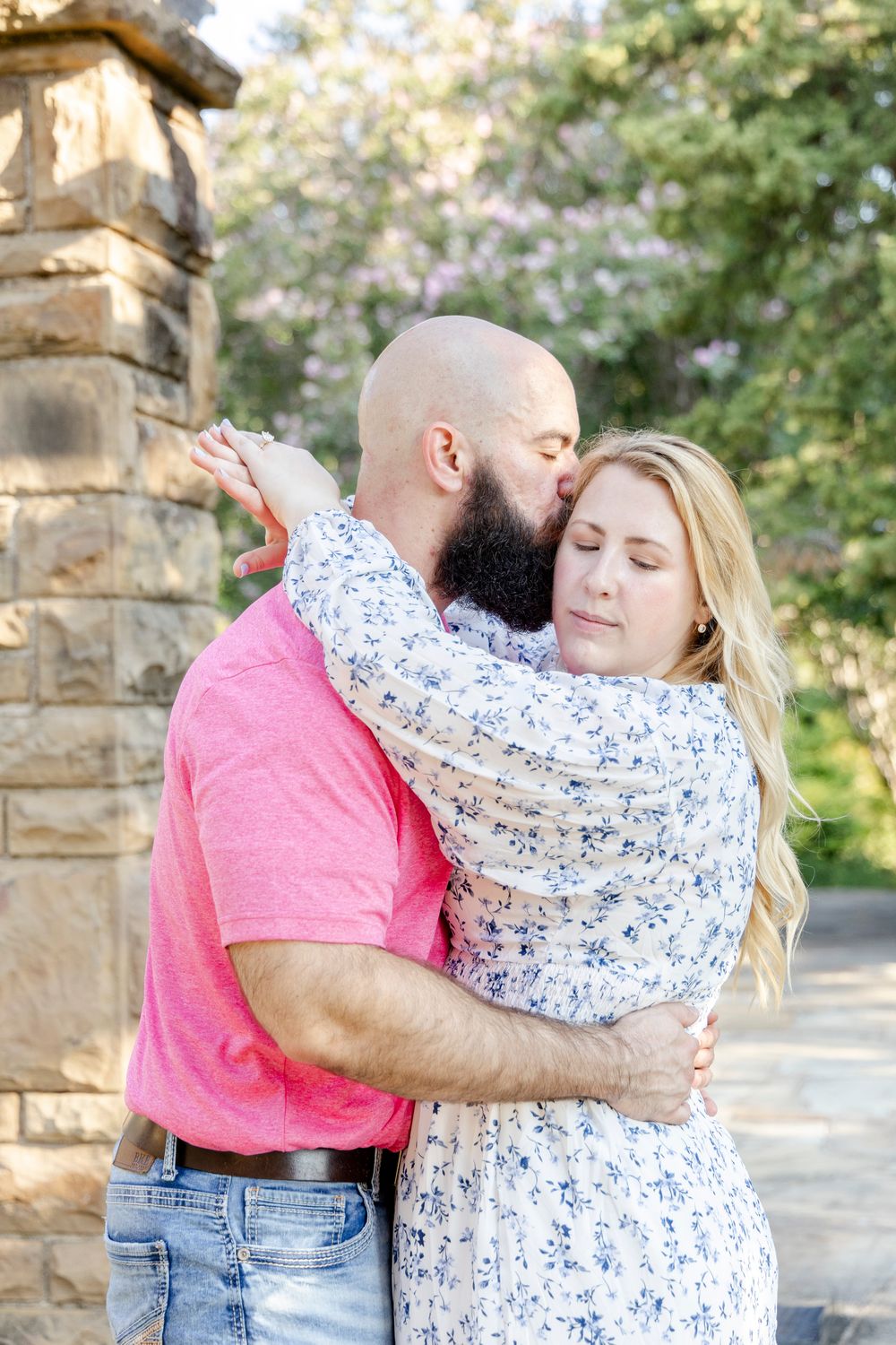Playful couple enjoying morning engagement photos at a botanical garden
