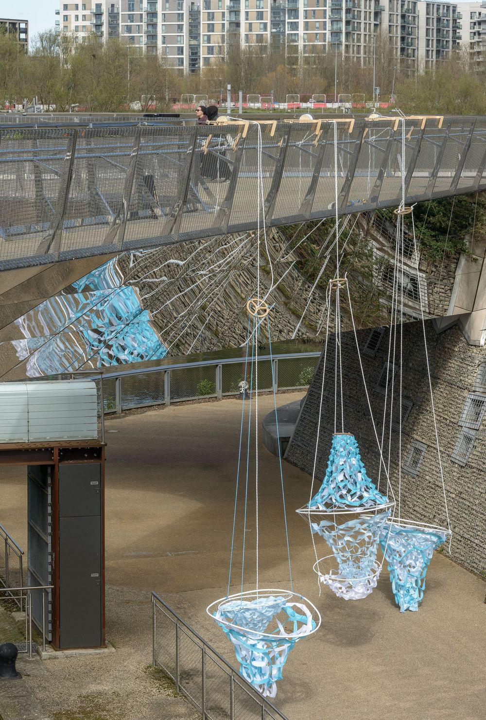 Bartlett Meng installation of fabric lanterns with cable movement devices hanging from bridge in the Queen Elizabeth Olympic park, London.by