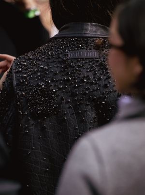 Close up of black beaded embellishment on a Miu Miu garment with sparkly crystal details.