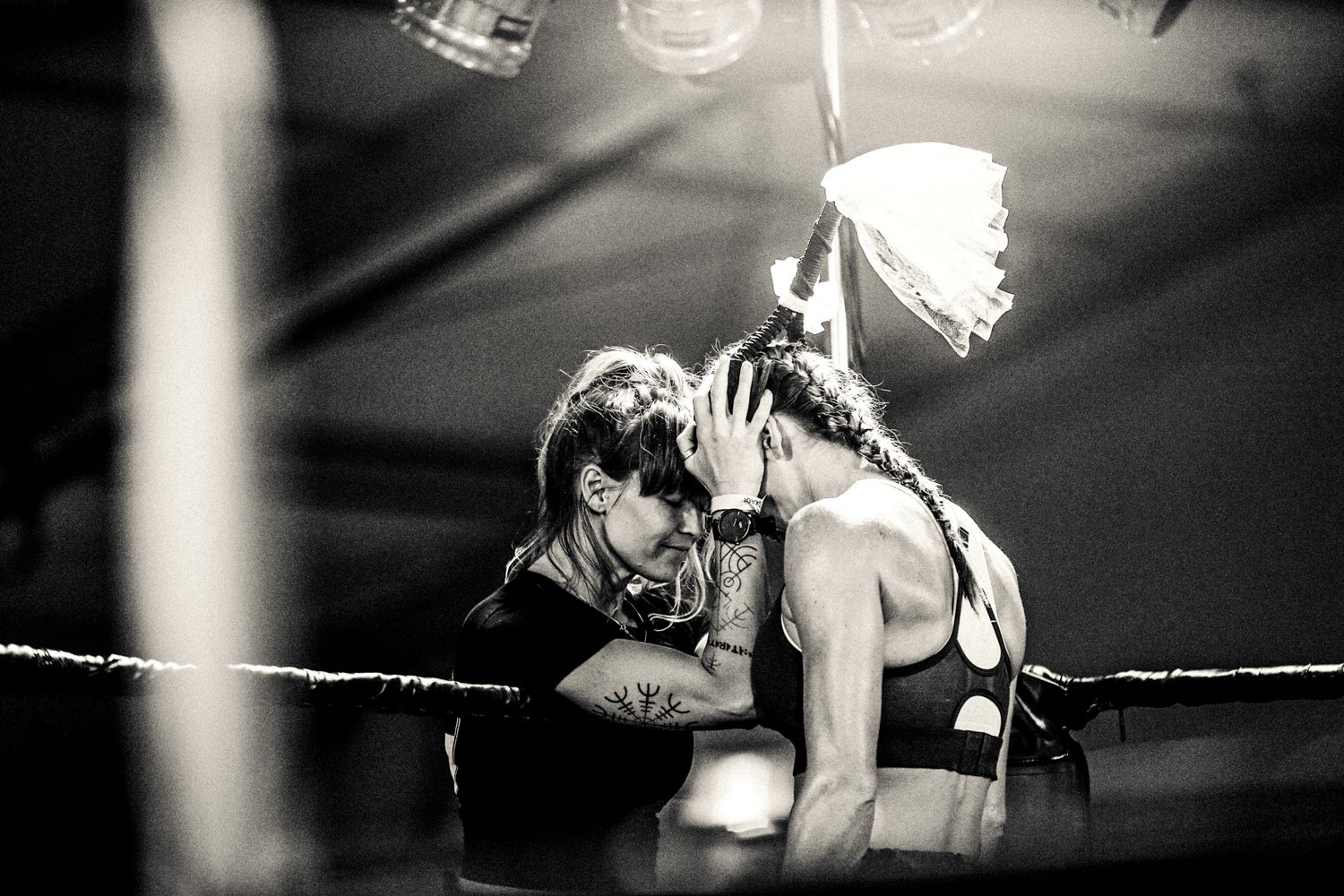 Dramatic black and white photo of two wrestlers during a match.