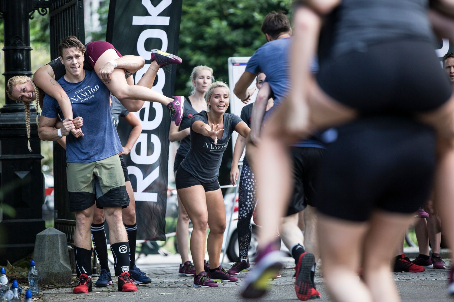 Athletes performing exercises during an outdoor fitness competition event.