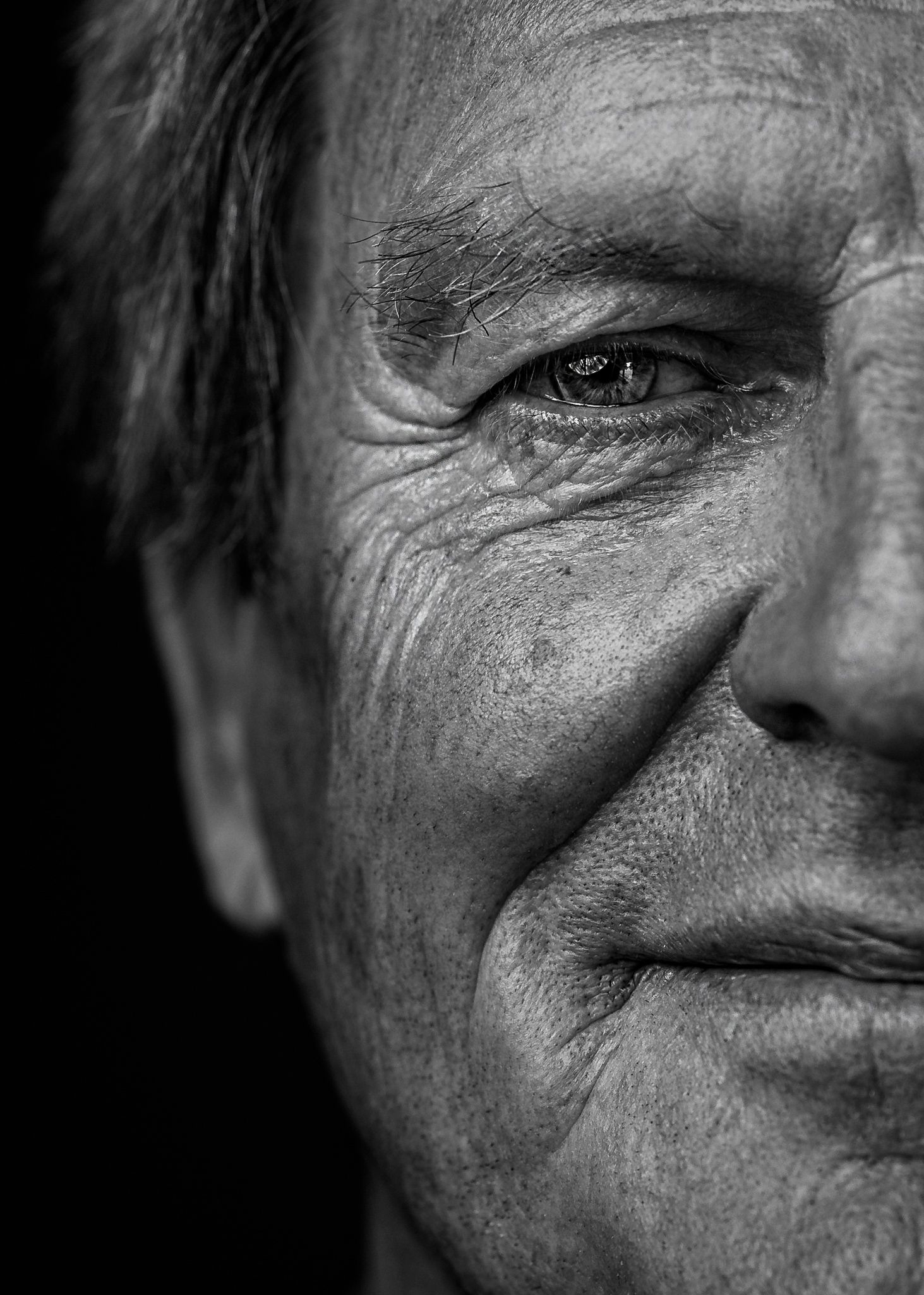 Black and white close-up portrait showing detail and texture in partial face view.