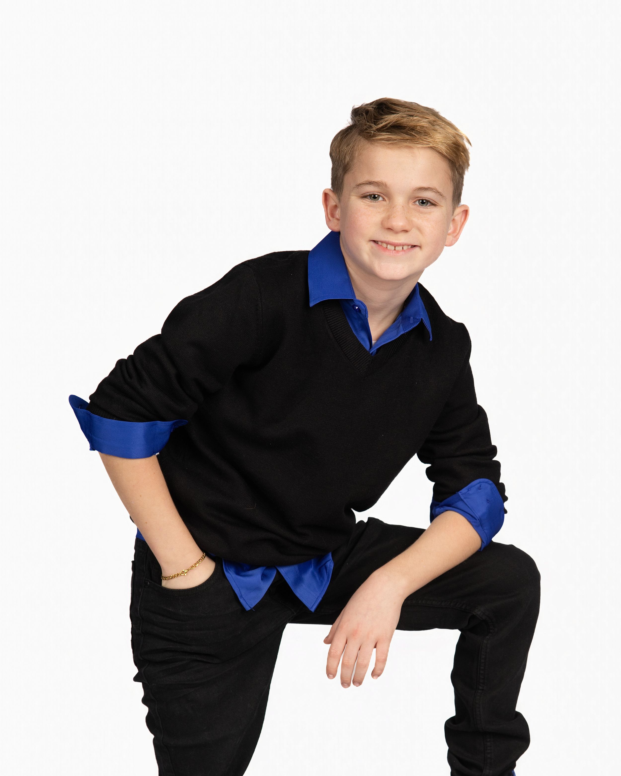 A young person in a black shirt and blue collar crouches in three dynamic poses against a white background.
