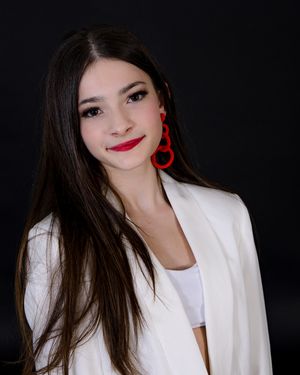 A series of portrait photos showing someone wearing a white blazer and red earrings against a dark background.