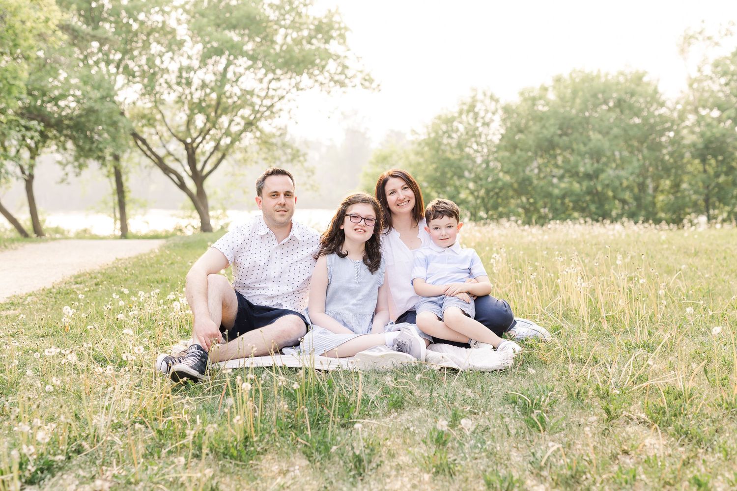 Romantic sunset maternity photo with couple in pink and white.