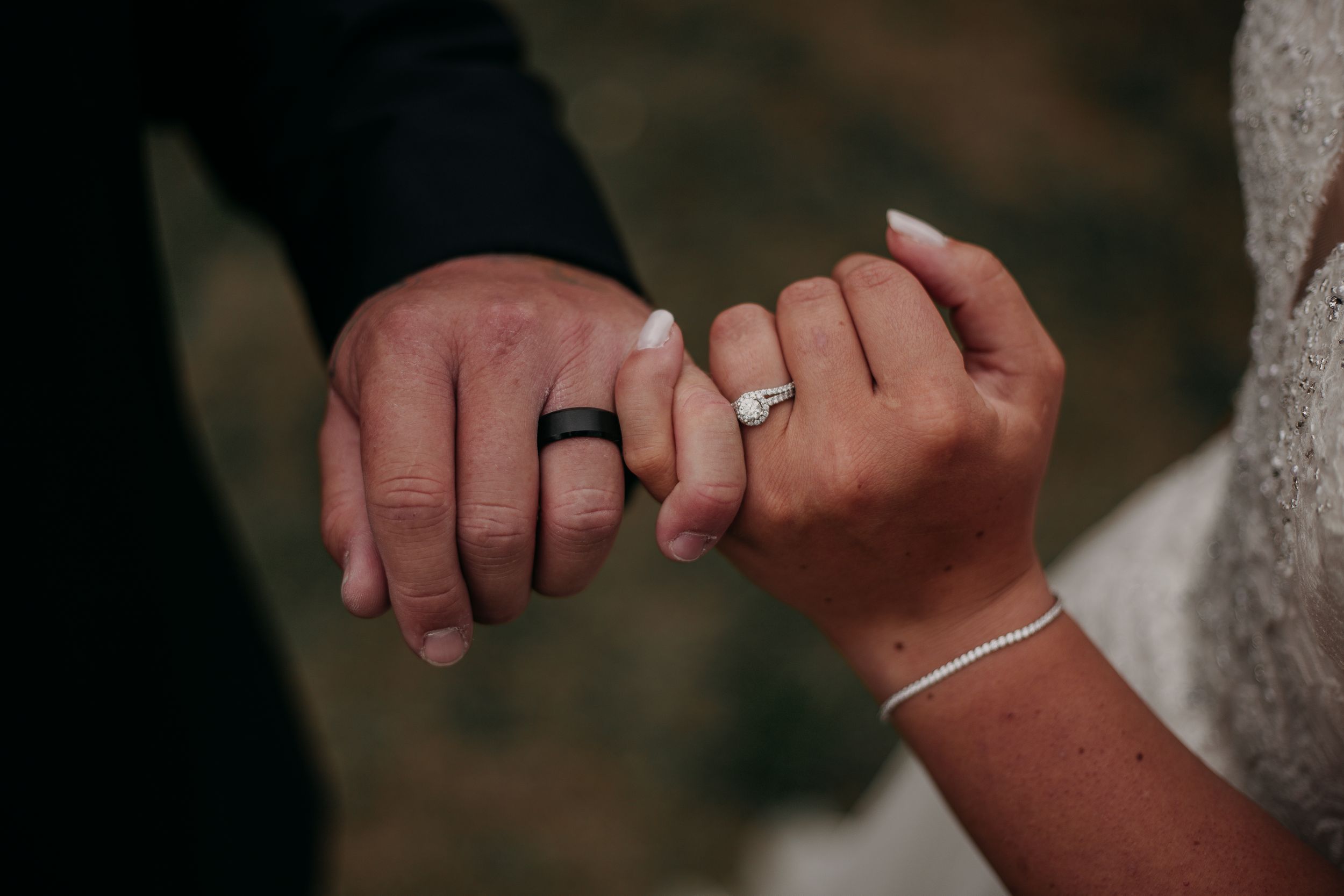 A close-up sequence of hands exchanging wedding rings during a marriage ceremony.