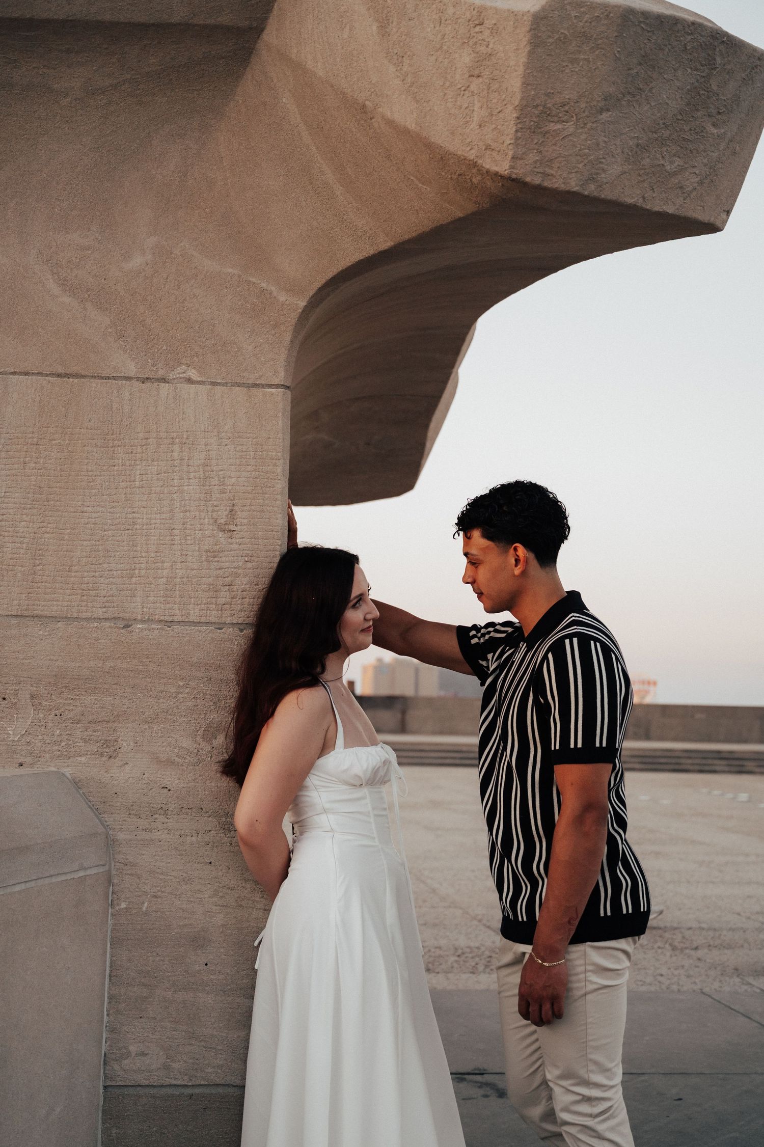 kansas city engagement shoot, man and woman leaning on wall