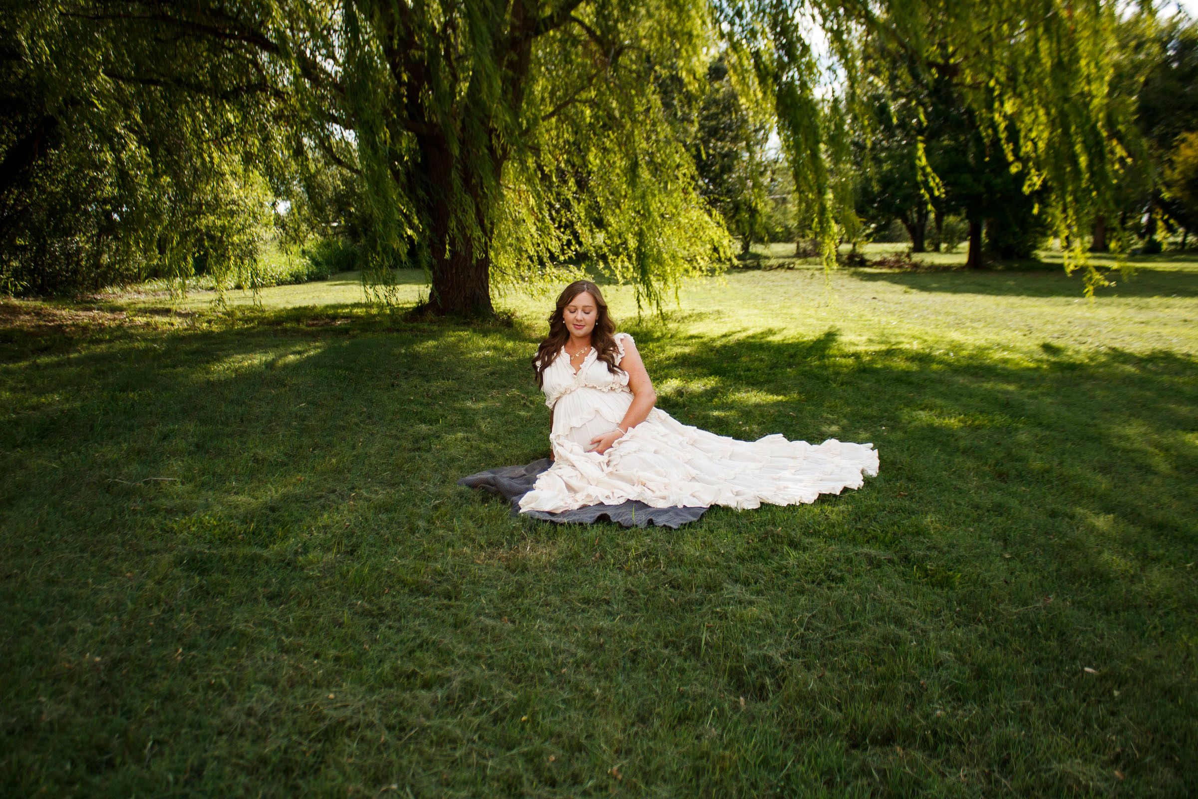 An expecting mother during a maternity photo session at Willow Tree Park in Canyon, Texas