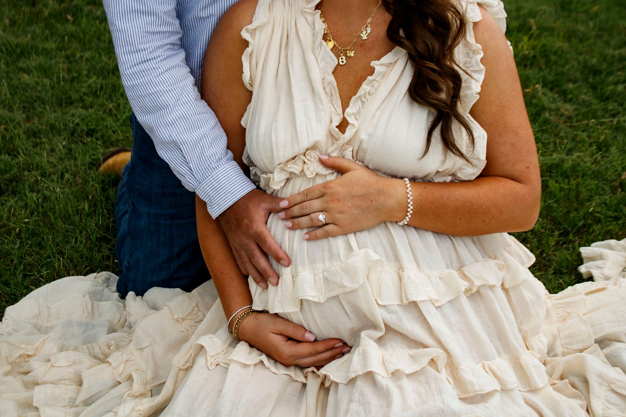 An expecting couple during a maternity photo session at Willow Tree Park in Canyon, Texas