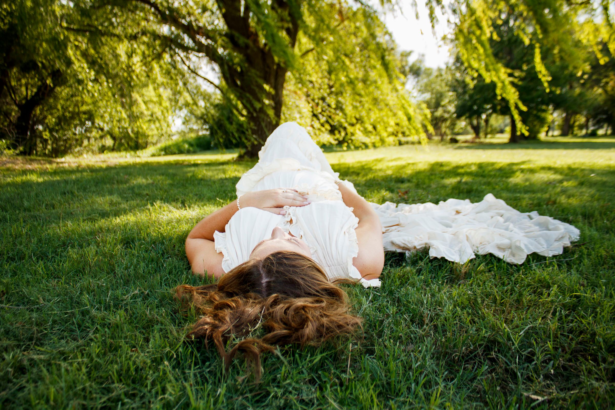 An expecting mother during a maternity photo session at Willow Tree Park in Canyon, Texas
