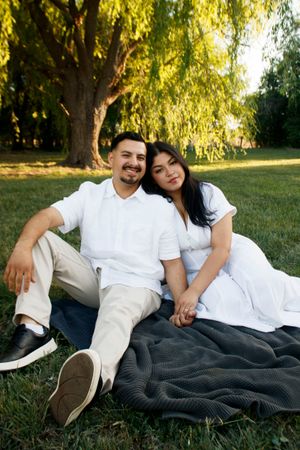 A young couple during a family photo session at Willow Tree Park in Canyon, Texas