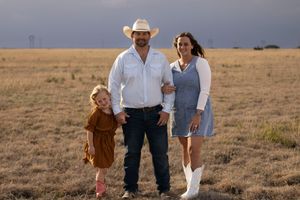 A family of three during a family photo session at an open field in Amarillo, Texas