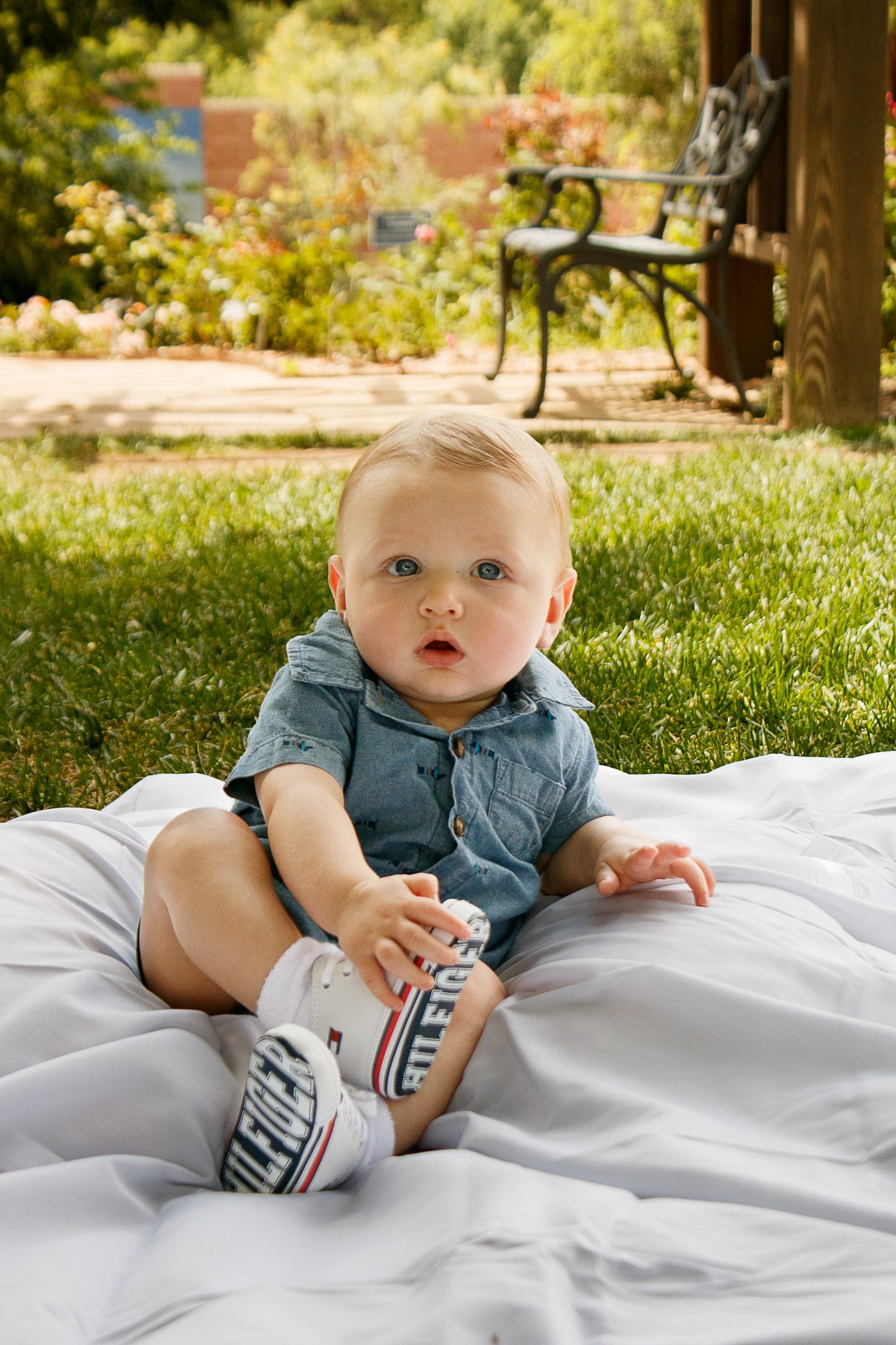A baby boy during a six-month cake smash photo session at the Botanical Gardens in Amarillo, Texas