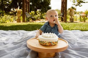 A baby boy during a six-month cake smash photo session at the Botanical Gardens in Amarillo, Texas