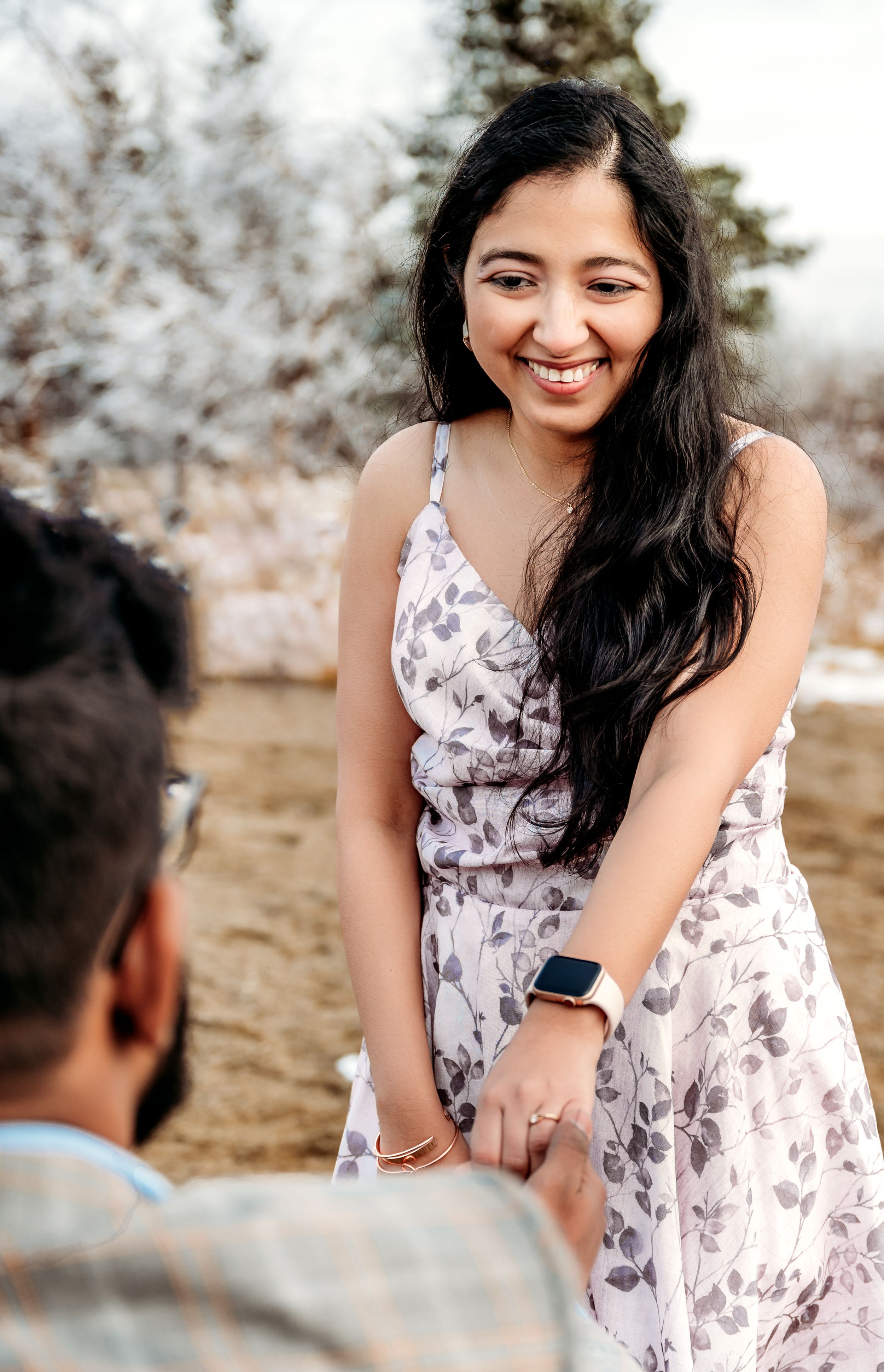 A joyful moment captured during a mountain proposal.