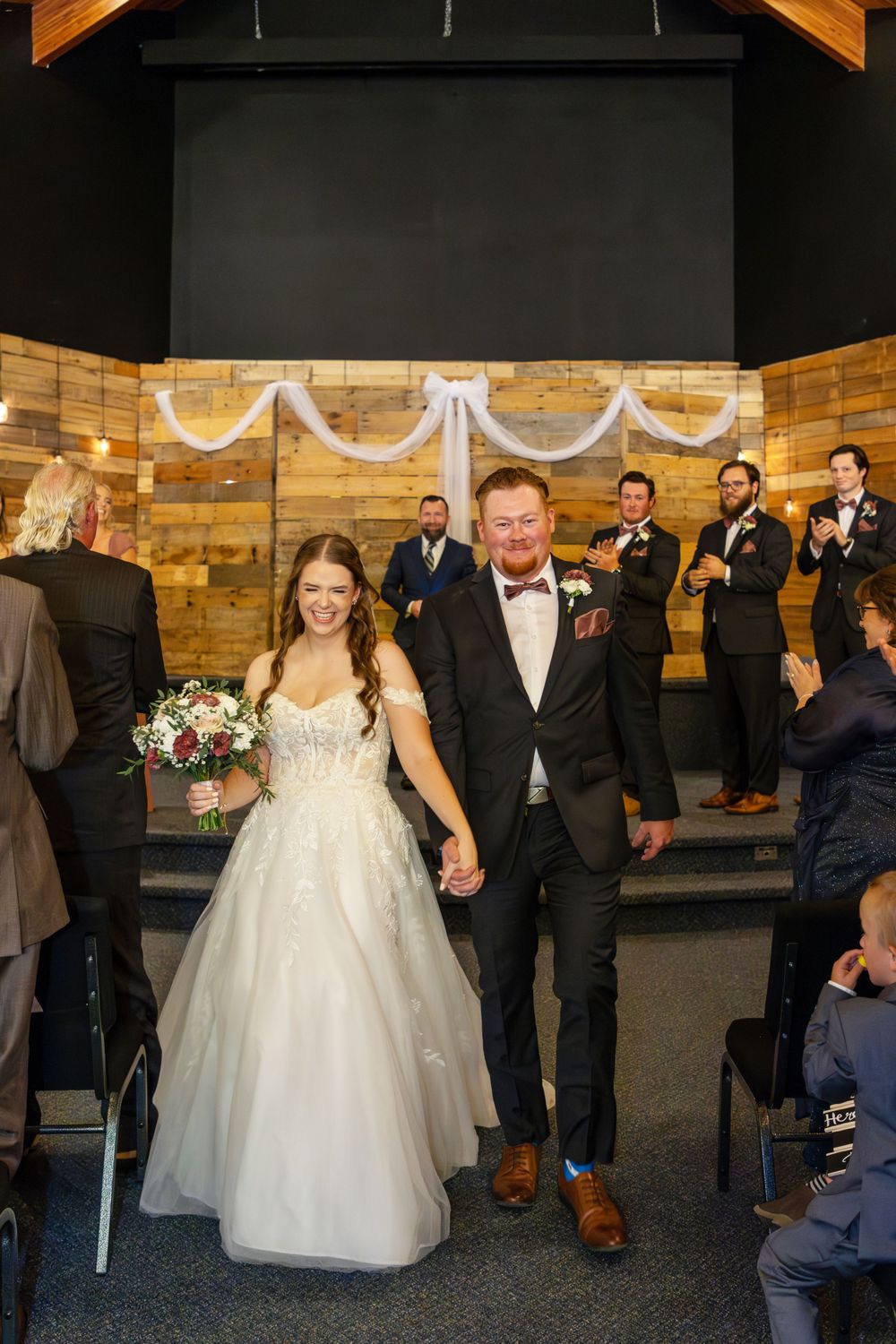 Bride and groom walking out of their wedding ceremony just have been pronounced husband and wife