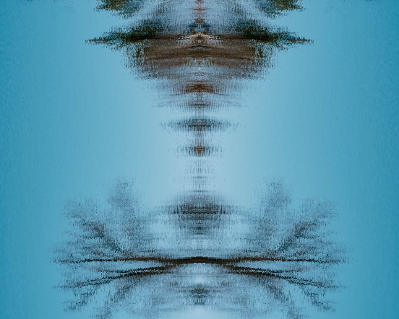 Abstract blue and black symmetrical pattern with mirror effect creating a blurred ethereal design against turquoise background.