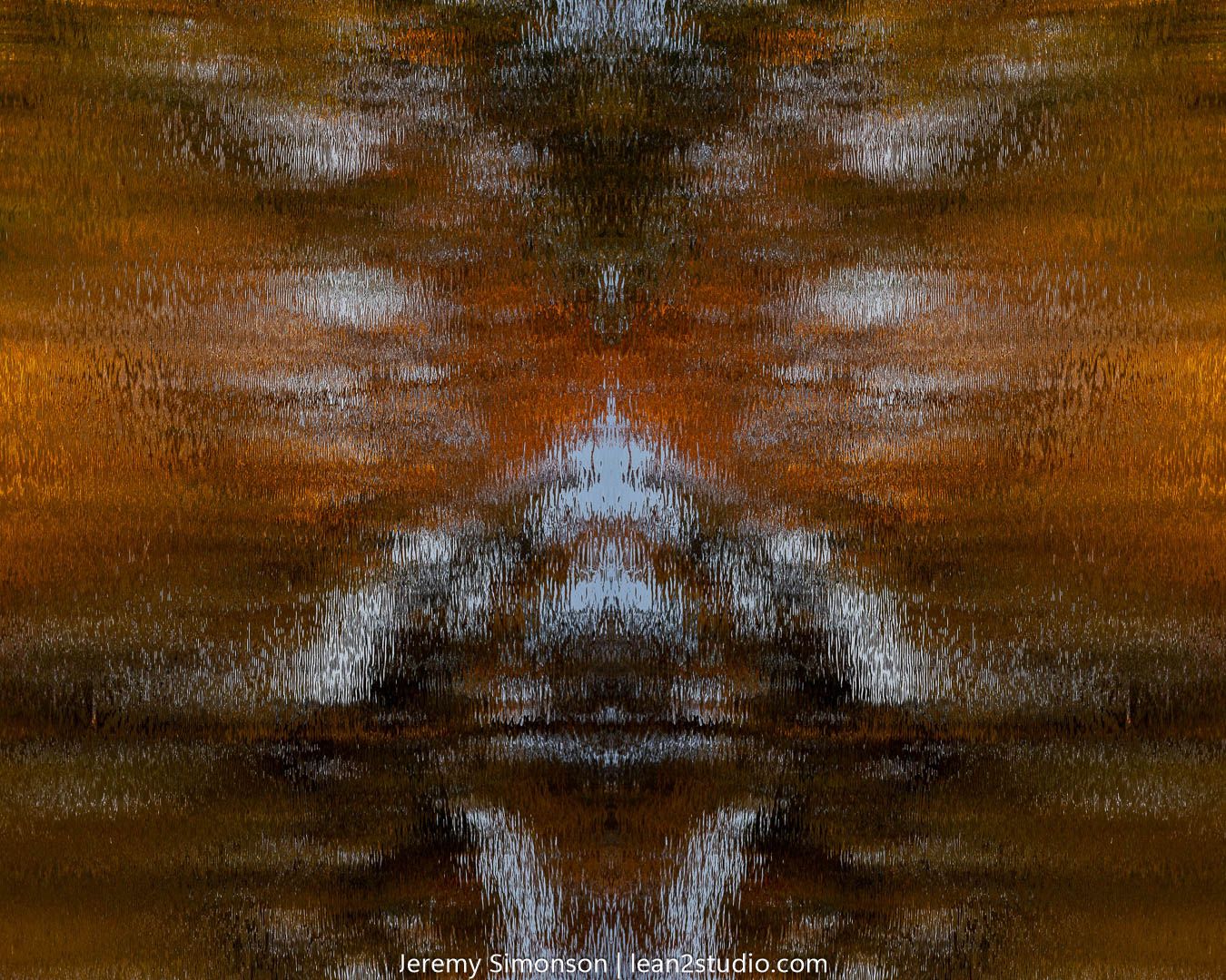 Abstract water reflection in orange and blue creating a symmetrical pattern.